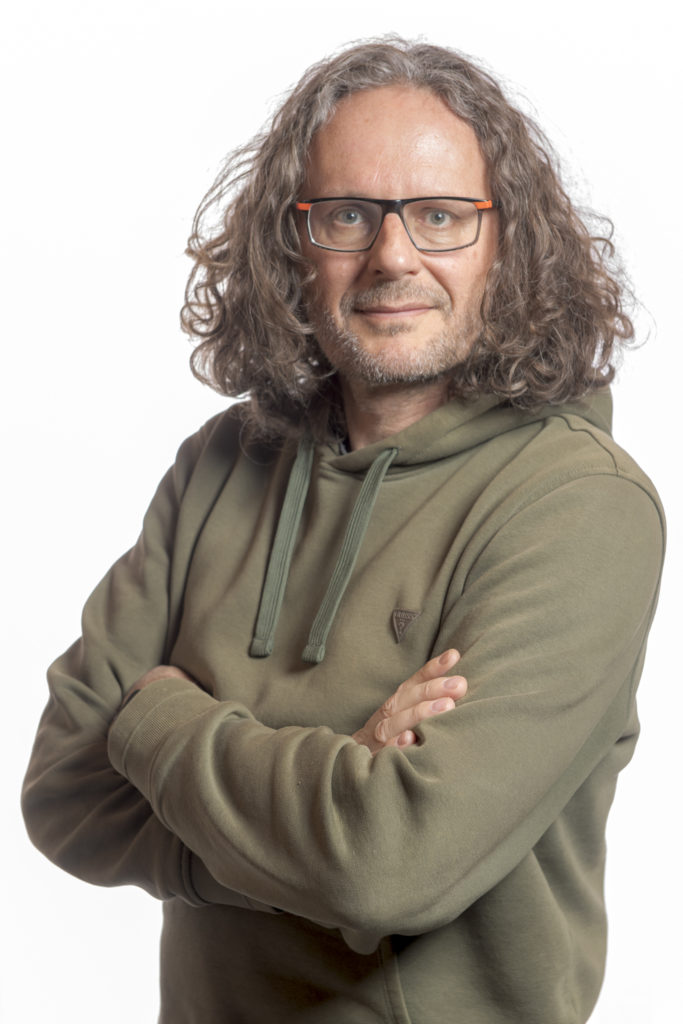 autoportrait de david casartelli bras croisés sur fond blanc réalisé par David Casartelli photographe de montagne à Samoëns